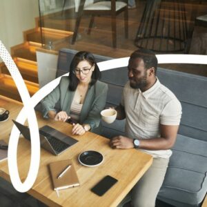 man on a sofa with a laptop and coffee