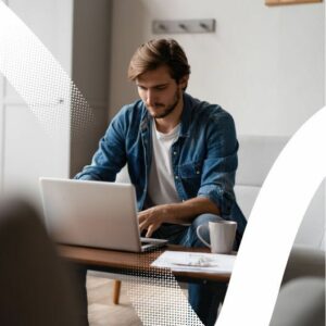 man on a sofa with a laptop