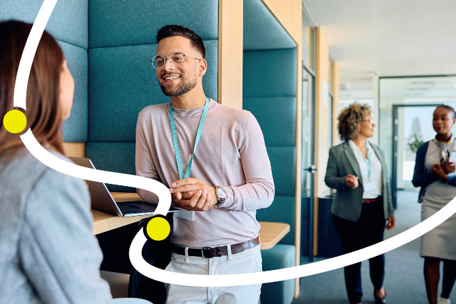 Onboarding white collar workers blog image. Two people in an office meeting for the first time.